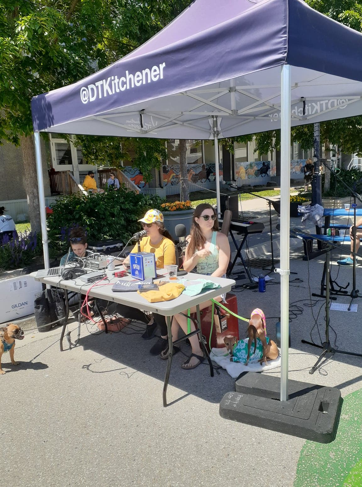 Midtown Radio volunteers broadcasting live from a tent at a downtown Kitchener street event